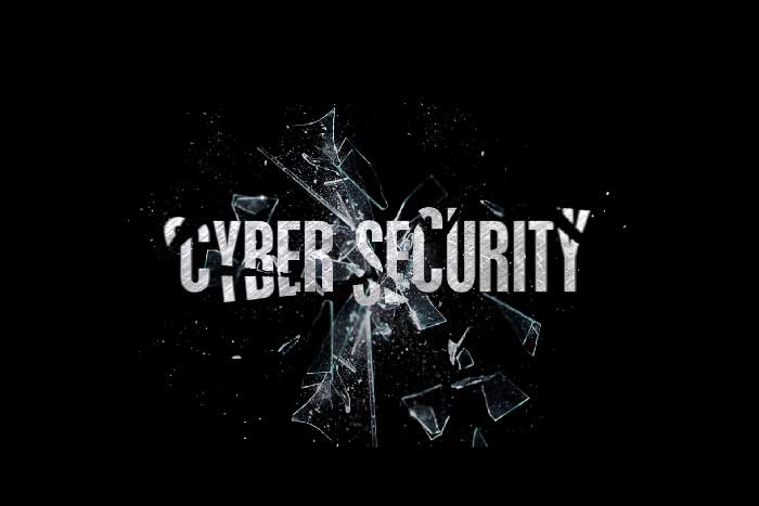 Broken glass over cyber security words
