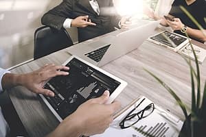 Consultants sitting around table with data