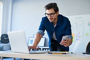 a client submitting a ticket for IT help desk support at his desk