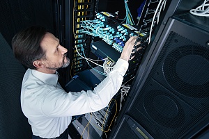 an outsourced IT service professional tending to a server rack