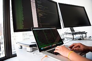 a managed IT services provider using multiple monitors to conduct services