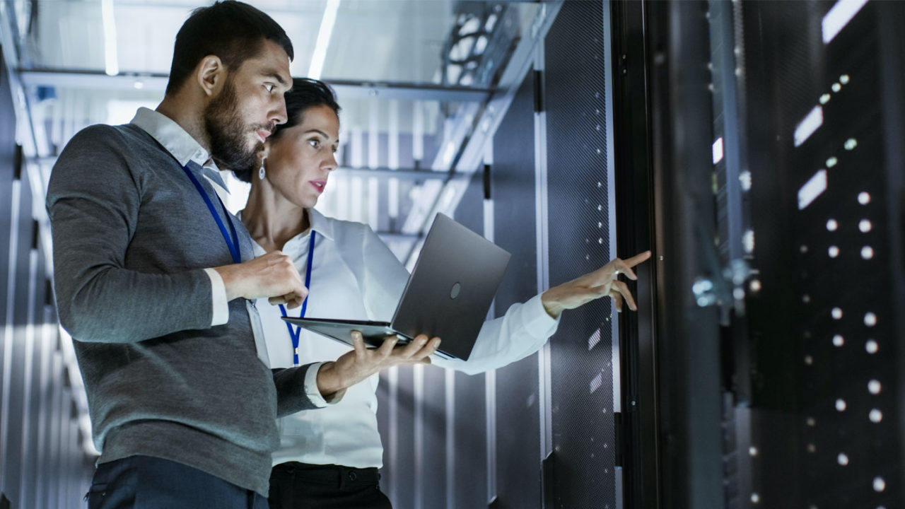 two employees monitoring a data center after a secure network installation