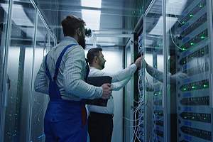 Two Technicians conducting repair and maintenance work in a data backup and recovery center