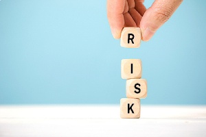 Wooden cubes with risk written on it. Depicting risk assessment and disaster recovery plan