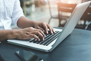 close up view of a person typing on their laptop in maryland