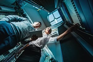 integration consultant speaking with a client inside of a server room in northern va