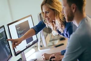 two people doing their job efficiently at a desktop computer because of expert it consulting in northern va