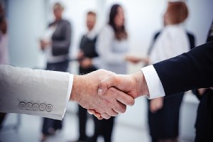 Business handshake. Reach out to the experts to learn more about how MSPs support in-house IT teams