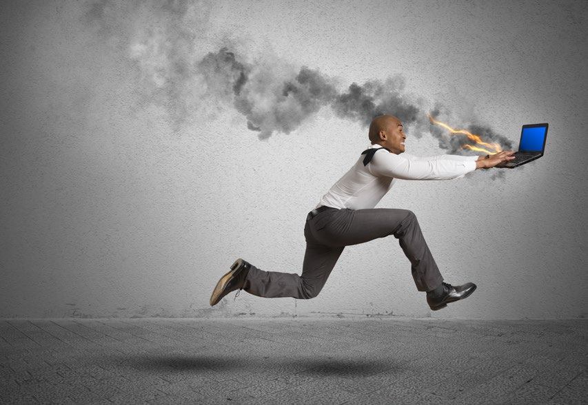 man running with a burning laptop