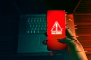 person holding mobile effeted by malware attack
