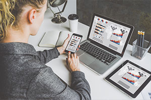 woman running business with phone and laptop