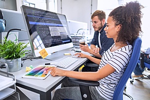 an employee reviewing cybersecurity best practices with her manager