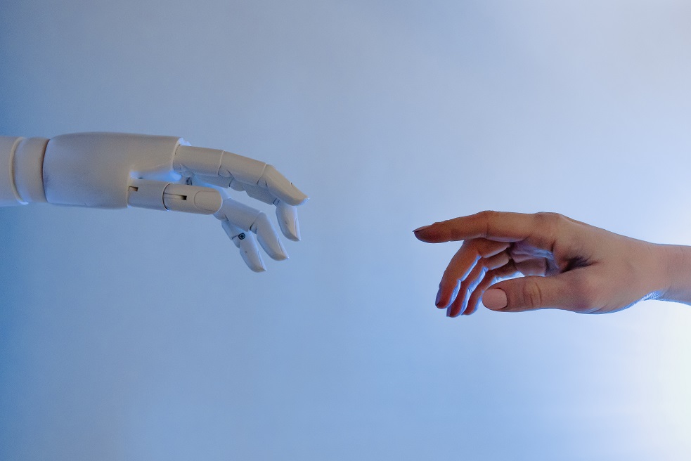 robotic hand reaching out to a human's hand