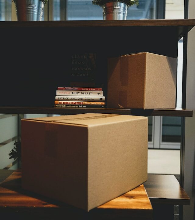 boxes in the office shelf, showing that employees are moving offices