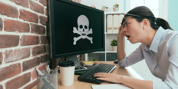 A scared employee seeing a scareware on her computer