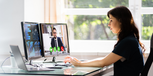 An employee working while in a meeting, showing how collaboration tools work