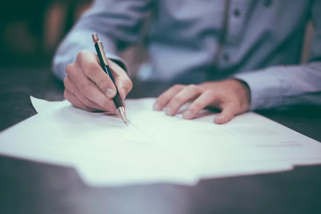 A business owner signing a contract with an IT support